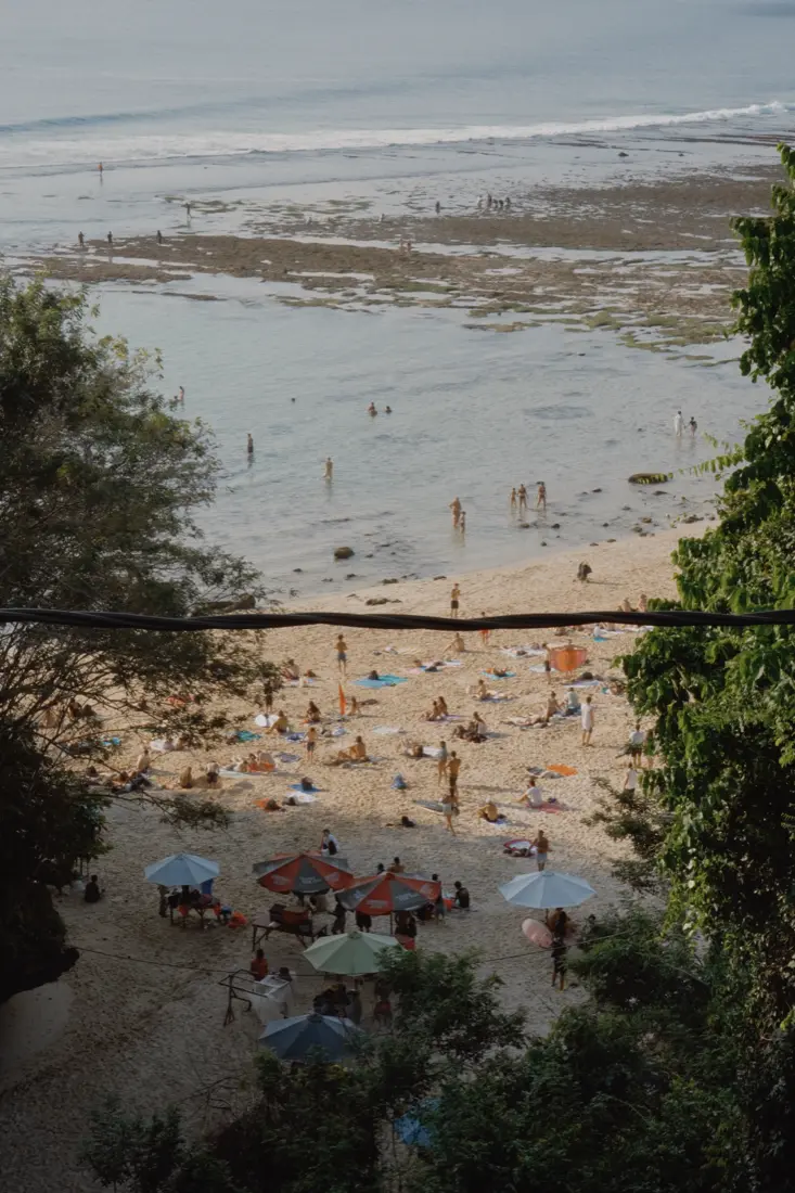 Parasols and swimmers on the beach in Bali, seen from above